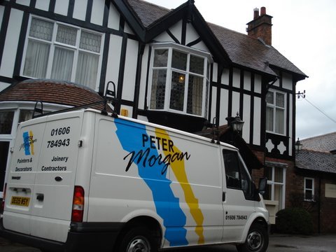 Peter Morgan van outside a Tudor style building