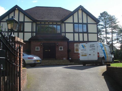Tudor style home decorated by Peter Morgan, with company van on the drive